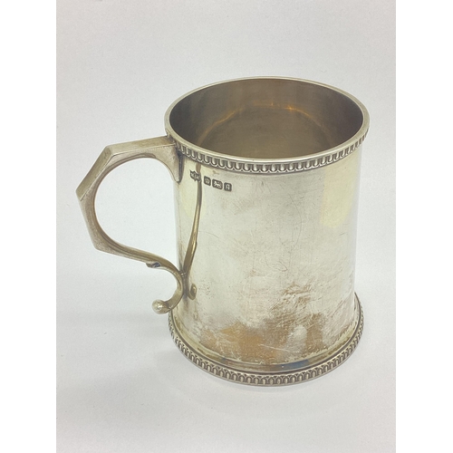 53 - A Hallmarked Silver Mug, Mappin & Webb, Sheffield 1908, of plain tapering cylindrical form with text... 