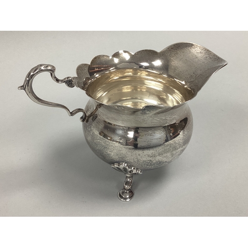58 - A Hallmarked Silver Jug, William Aitken, Birmingham 1909, of circular form with wavy cut edge, wide ... 