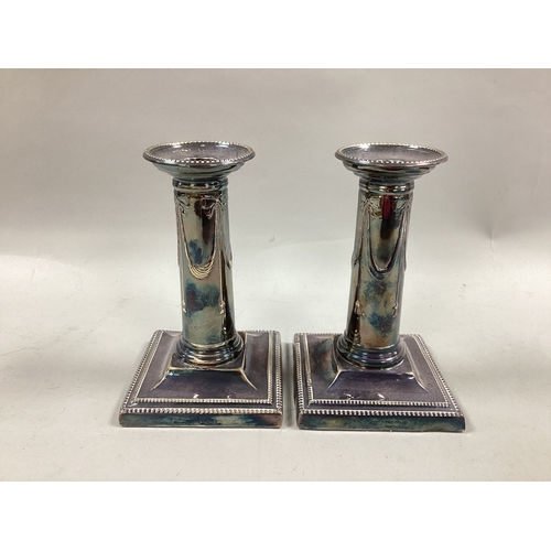 22 - A Pair of Hallmarked Silver Dwarf Candlesticks, each column detailed in relief with ribbon tied swag... 