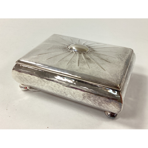 7 - A Rectangular Trinket Box, the hinged lid with textured design, raised on four bun feet, stamped 
