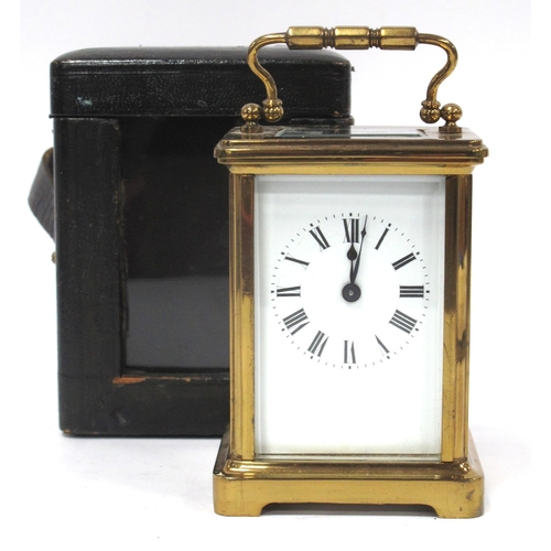 1340 - A XX Century Brass Carriage Clock, the white enamel dial with black Roman numerals,15cm high (handle... 