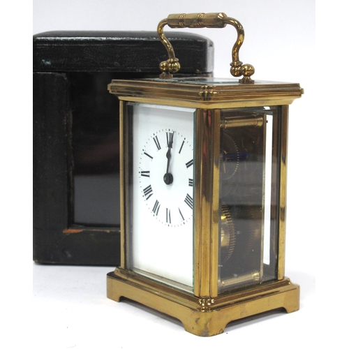 1340 - A XX Century Brass Carriage Clock, the white enamel dial with black Roman numerals,15cm high (handle... 