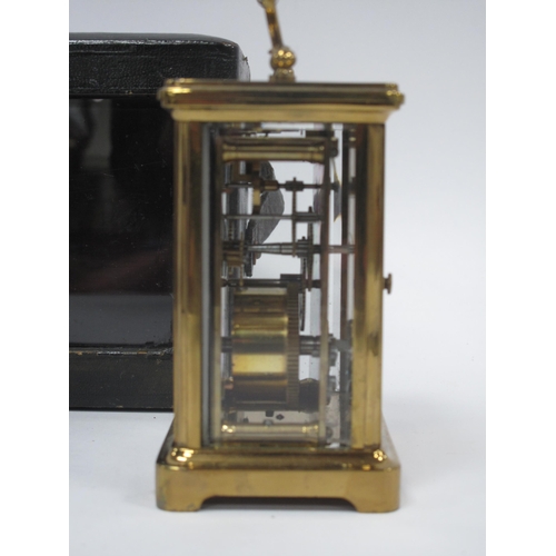 1340 - A XX Century Brass Carriage Clock, the white enamel dial with black Roman numerals,15cm high (handle... 