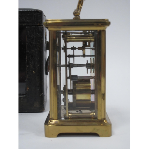 1340 - A XX Century Brass Carriage Clock, the white enamel dial with black Roman numerals,15cm high (handle... 