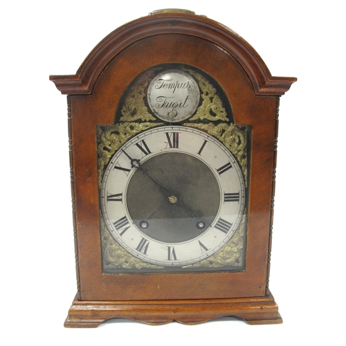 1342 - A Mid XX Century Mantle Clock, the walnut case with arched top, turned side columns and stepped base... 