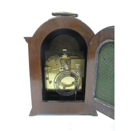 1342 - A Mid XX Century Mantle Clock, the walnut case with arched top, turned side columns and stepped base... 