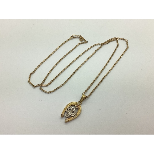 114 - A Modern Horseshoe Pendant, with inset highlights, stamped 