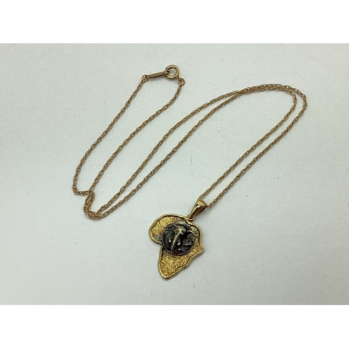 116 - A Modern Pendant in The Shape of Africa, detailed with elephant mask, stamped 