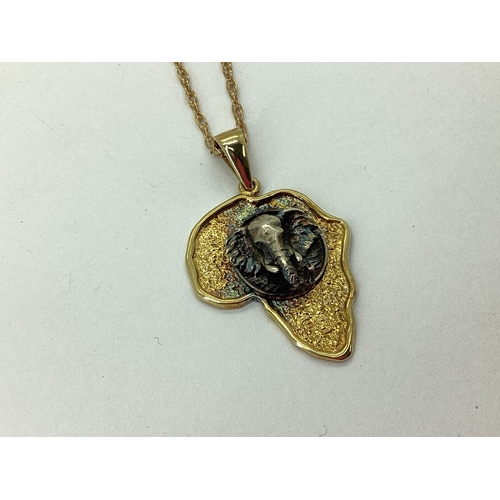 116 - A Modern Pendant in The Shape of Africa, detailed with elephant mask, stamped 