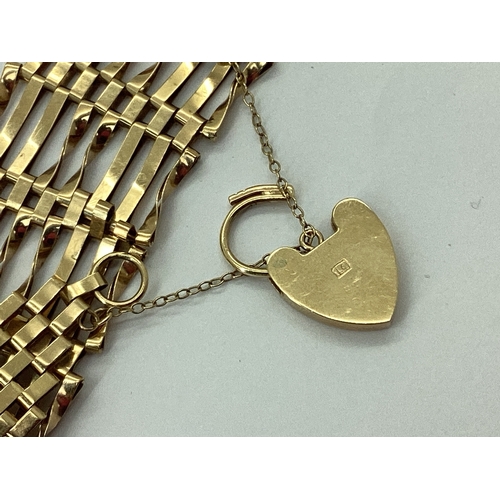 129 - A Wide 9ct Gold Gate Link Bracelet, to heart shape padlock clasp and safety chain, overall length ap... 