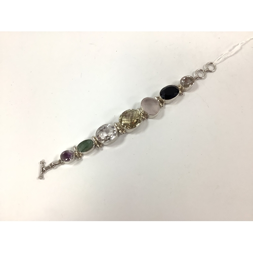 187 - A Modern Chunky Multi Set Bracelet, graduated collet set throughout, to T-bar and loop fastener, sta... 