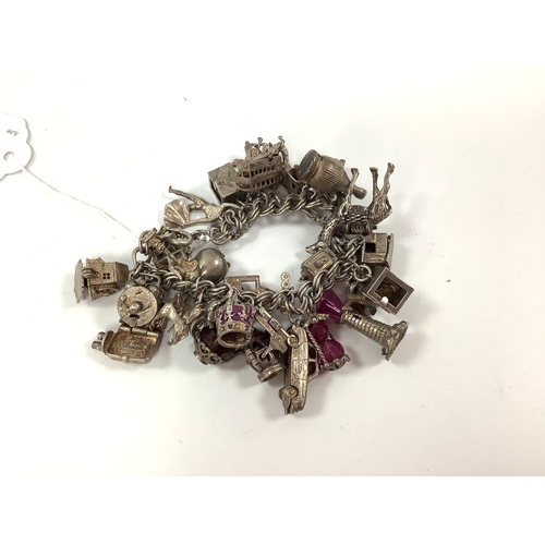 200 - A Double Curb Link Charm Bracelet, suspending numerous assorted novelty charm pendants, including ca... 
