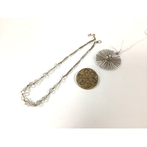 205 - A Modernist Style Single Stone Pendant, circular collet set; together with a decorative gilt brooch ... 