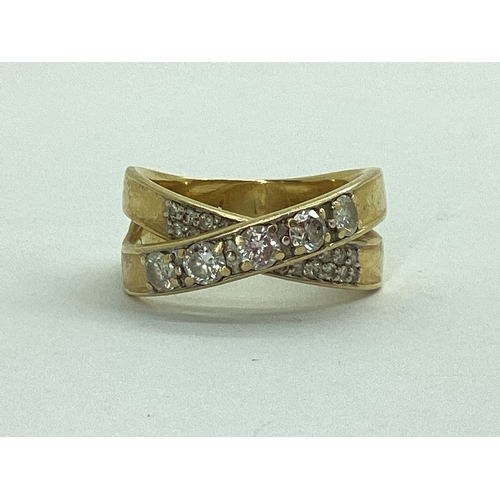 47 - A Modern Diamond Set Dress Ring, of crossover design, stamped 
