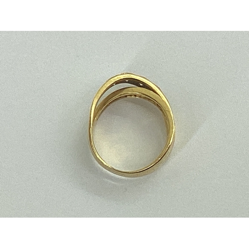 47 - A Modern Diamond Set Dress Ring, of crossover design, stamped 