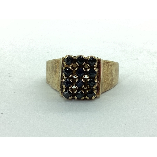 49 - A Chunky Stone Set Signet Style Ring, claw set throughout, between wide tapered shoulders, stamped 