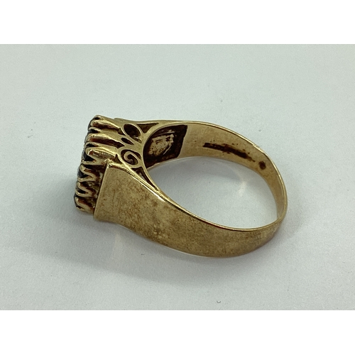 49 - A Chunky Stone Set Signet Style Ring, claw set throughout, between wide tapered shoulders, stamped 