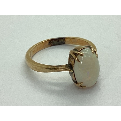 54 - An Opal Single Stone Dress Ring, oval cabochon claw set, stamped 