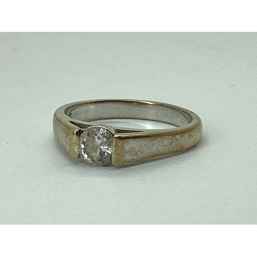 72 - A Single Stone CZ Set Ring, between plain tapered shoulders, stamped 