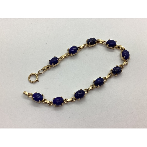 80 - A Lapis Lazuli Set Line Bracelet, uniform oval cabochon claw set (one cracked, one chipped), clasp s... 