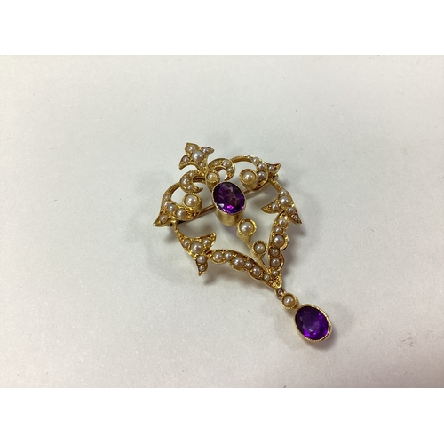 97 - A Decorative Edwardian Pendant/Brooch, the oval collet setting within openwork foliate style border,... 