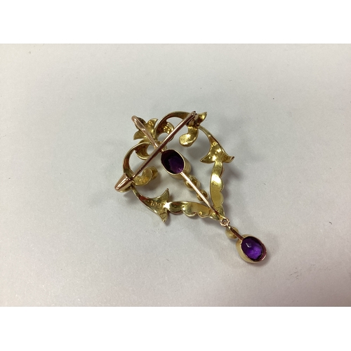 97 - A Decorative Edwardian Pendant/Brooch, the oval collet setting within openwork foliate style border,... 