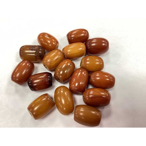 207 - A Vintage Cherry Amber Colour Single Strand Bead Necklace, together with a polished garnet bead neck... 