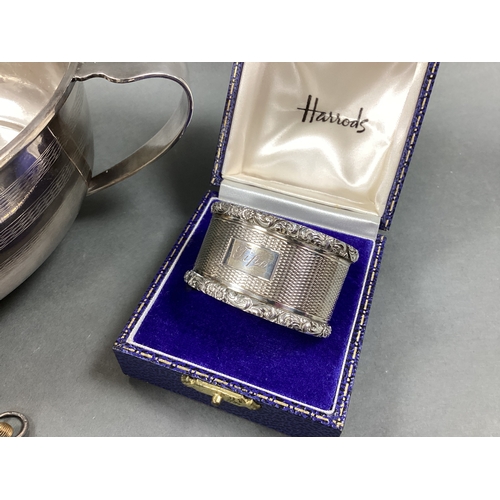 42 - A Hallmarked Silver Napkin Ring, allover engine turned decoration, with textured edge, inscribed 'Ti... 