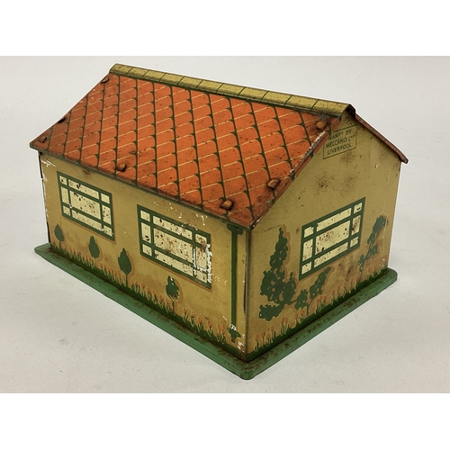 876 - A pre-war tinplate Dinky garage complete with two opening doors. Overall signs of wear.