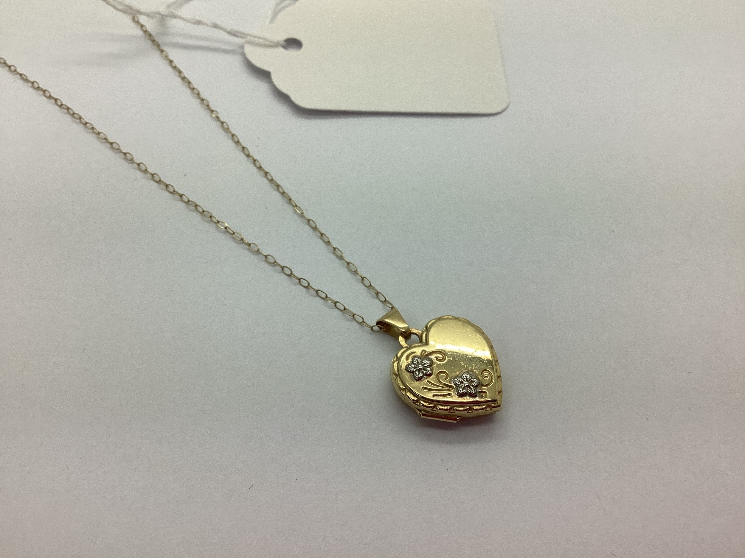 A Modern 9ct Gold Heart Shape Locket Pendant, foliate detail to the ...