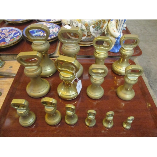 67 - Fourteen Brass Bell Weights