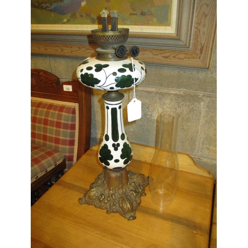 300 - Overlaid Green Glass Oil Lamp on a Cast Metal Base, with Funnel