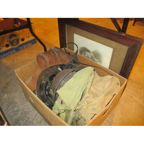 31 - Box with 2 Tin Helmets, German and Gibraltar Buckle Belts, Gas Masks etc and a Picture
