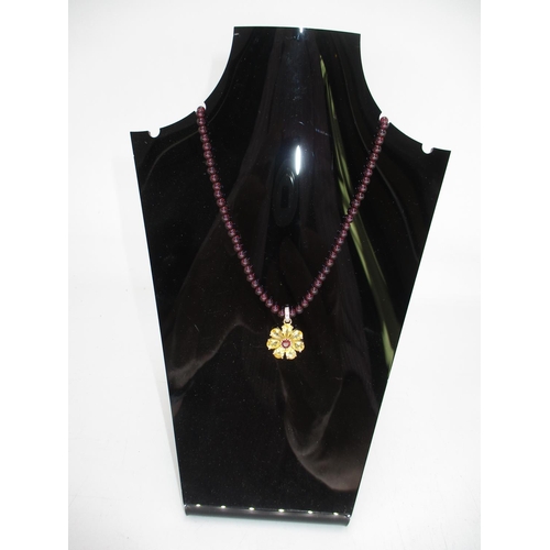 455 - 14K Gold Gem Set Flower Pendant on a Red Stone Necklace