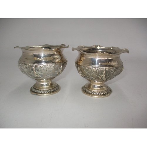 586 - Pair of Eastern White Metal Ornately Embossed Pedestal Pots, 8cm high, 180g