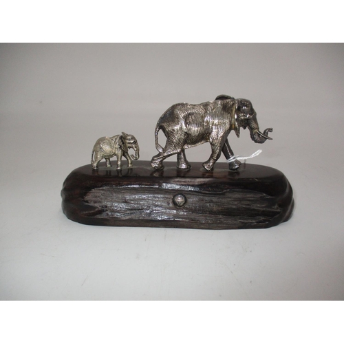 608 - Patrick Mavros, Zimbabwe, Silver Group of Elephants on a Wooden Base, 16cm