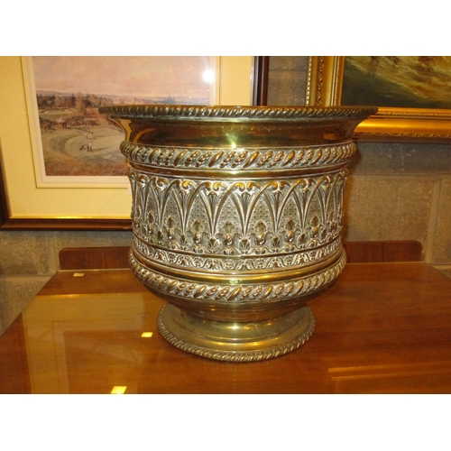 95 - Eastern Embossed Brass Jardinière, 33cm high, 37cm diameter