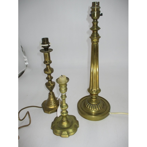 173 - Two Brass Lamps and a Candlestick