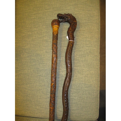 235 - Two Chinese Carved Wood Walking Sticks