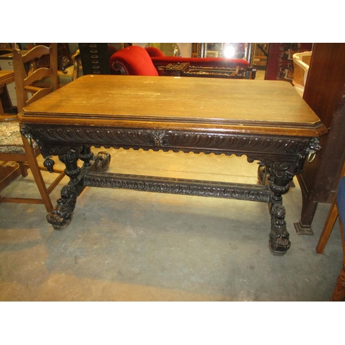 767 - Victorian Gothic Carved Oak Library Table having a Frieze Drawer and Lion Mask Corners and Supports,... 