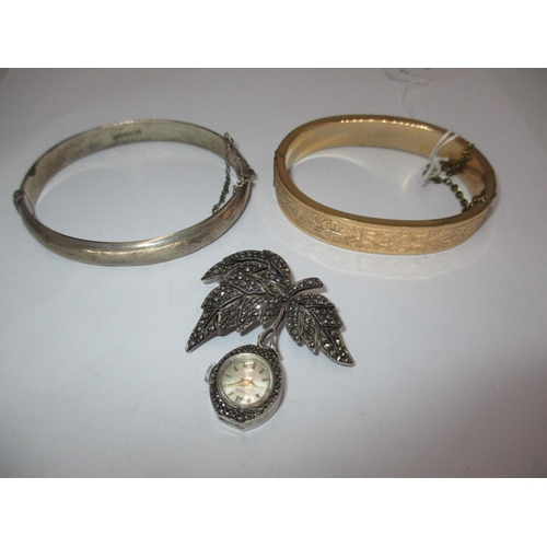 484 - Silver and Marcasite Nivada Brooch Watch, a Silver Bangle and a Gold Plated Bangle