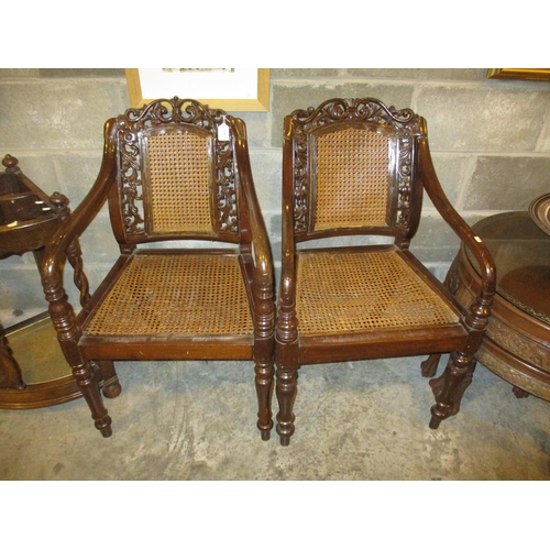 665 - Pair of Eastern Dark Wood and Bergere Elbow Chairs