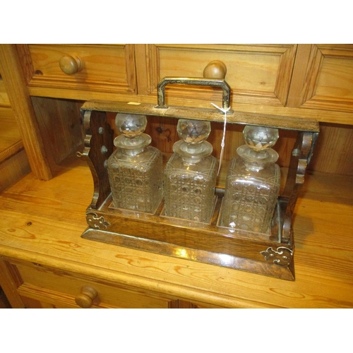 128 - Oak and Silver Plate Tantalus with 3 Decanter (handle and lock faulty)