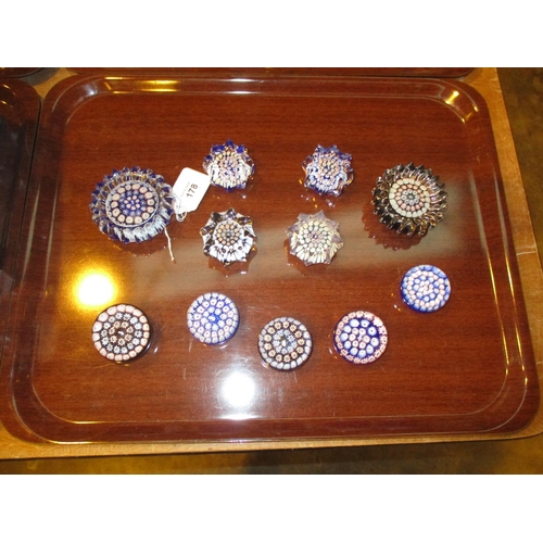178 - Eleven St Kilda Glass Paperweights, 10 with John Deacons Labels