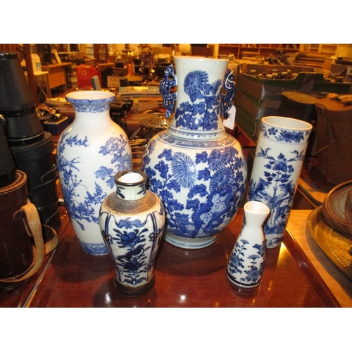 81 - Four Oriental Blue and White Vases and a Sake Bottle, large vase damaged, cylindrical vase cracked, ... 