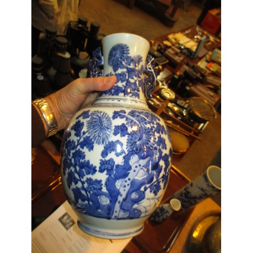 81 - Four Oriental Blue and White Vases and a Sake Bottle, large vase damaged, cylindrical vase cracked, ... 