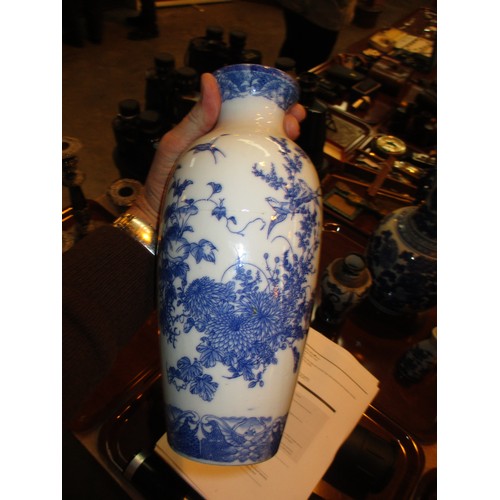 81 - Four Oriental Blue and White Vases and a Sake Bottle, large vase damaged, cylindrical vase cracked, ... 