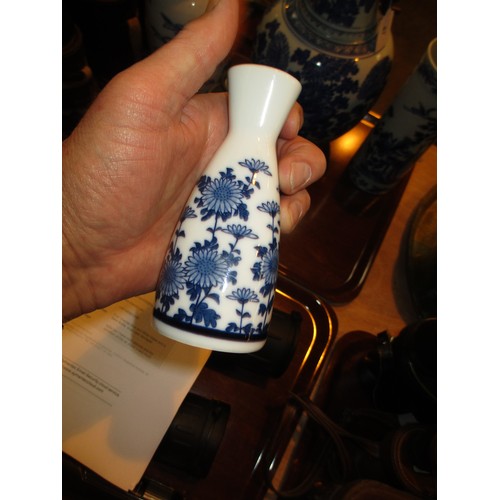 81 - Four Oriental Blue and White Vases and a Sake Bottle, large vase damaged, cylindrical vase cracked, ... 