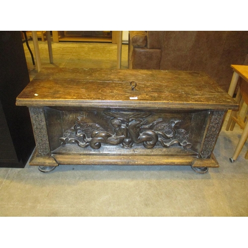 533 - Continental Oak Coffer the Front Panel Carved with Maidens Holding a Lily Pad, with key, 112x50x50cm