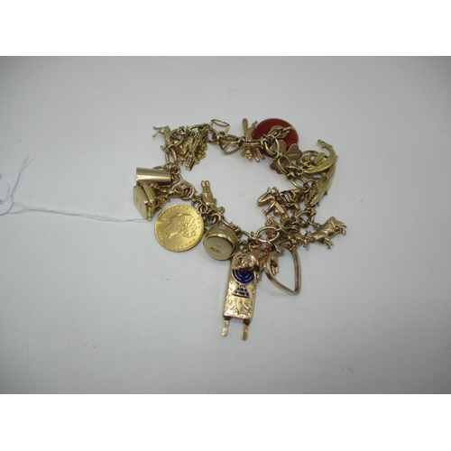 348 - 9ct Gold Charm Bracelet with 20 Charms including a Jewish Torah Scroll, Hard Stone Curling and Victo... 